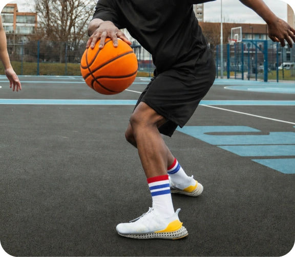 Athlete wearing black and white crew grip socks with athletic shoes.