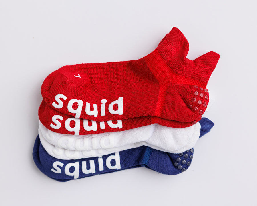 All-American ankle grip socks in red, white, and navy, stacked to show all three colors. By Squid Socks.