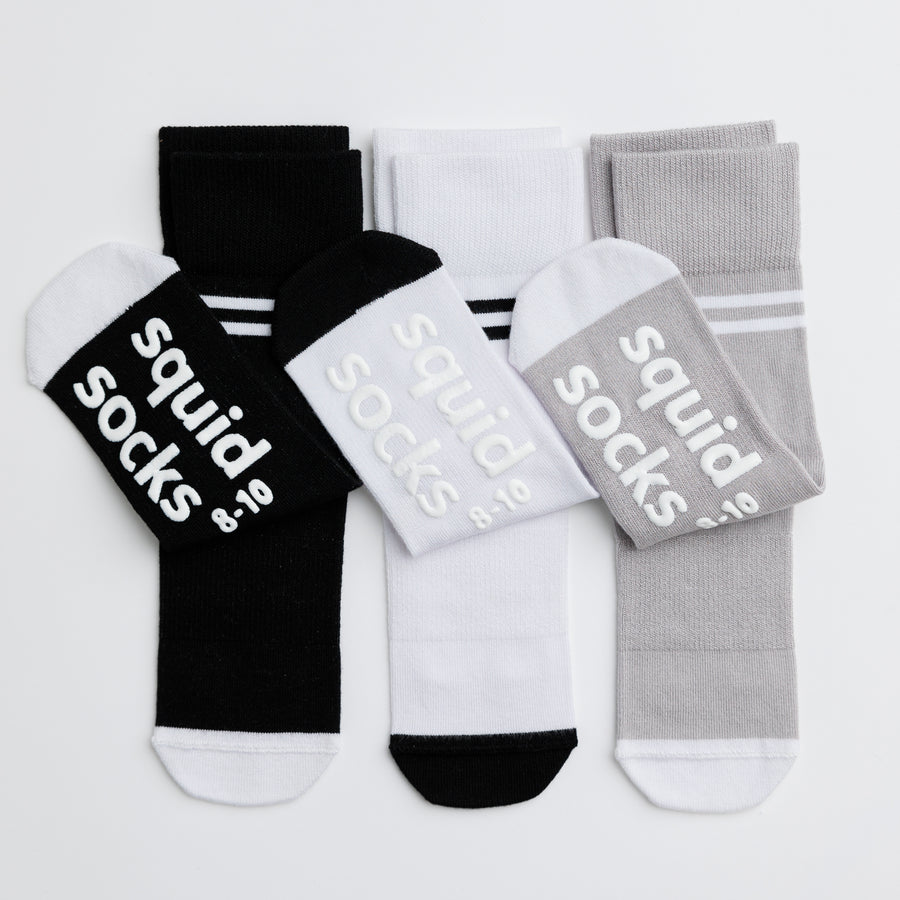 City kids socks: white, gray and black striped-cuff socks showing sole grips. Squid Socks, the brand seen on Shark Tank.
