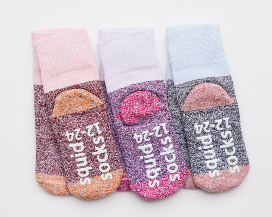 Chelsea cotton crew socks: three cotton crew socks showing contrasting heels and branded soles. Squid Socks, the brand seen on Shark Tank.