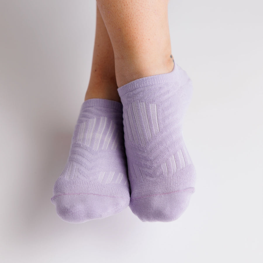 Front view of lavender no-show grip socks worn on both feet. By Squid Socks.