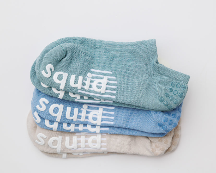 Seaside no-show grip socks in teal, blue, and cream, stacked to show all three colors. By Squid Socks.