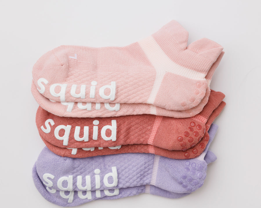 Perfectly Pastel ankle grip socks in light pink, coral, and lavender, stacked to show all three colors. By Squid Socks.