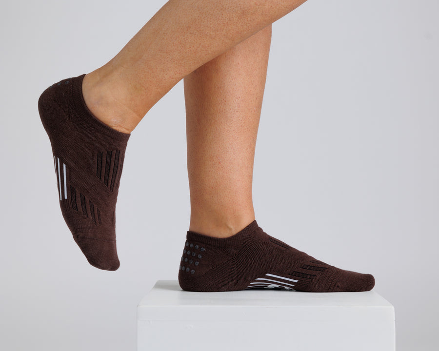Brown no-show grip socks worn on a display block, showing side and top views. By Squid Socks.