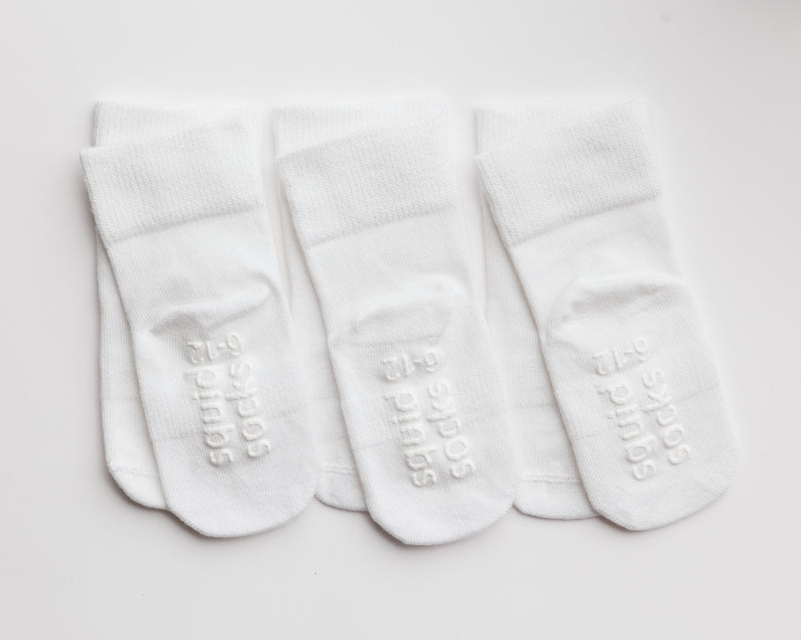 Cloud kids socks: three white socks showing sole grips. Squid Socks, the brand seen on Shark Tank.