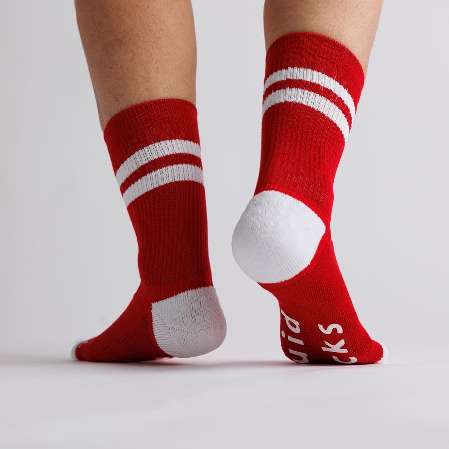 Red All-American crew grip socks viewed from behind, showing white heel panels. By Squid Socks.