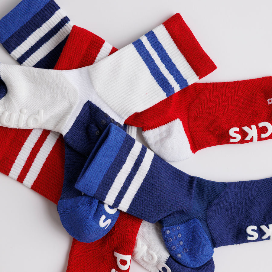 All-American crew socks arranged to show red, white, and navy striped cuffs and heel panels. By Squid Socks.