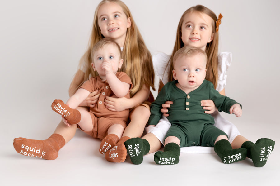 Cypress kids socks: children seated together wearing earth-tone socks. Squid Socks, the brand seen on Shark Tank.