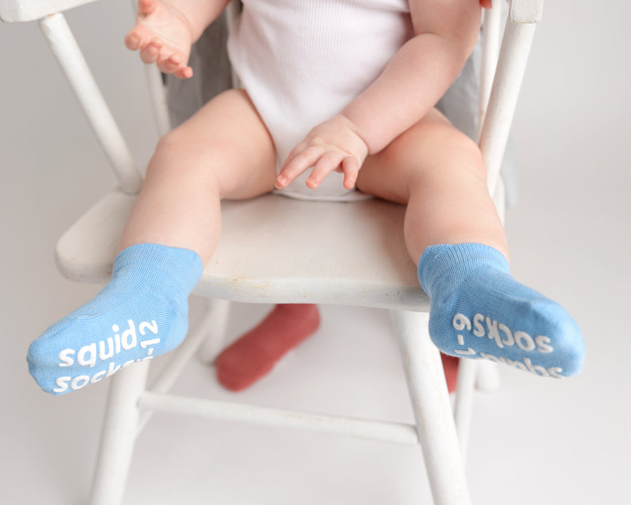 Chaney ankle socks: baby seated on a chair wearing blue ankle socks. Squid Socks, the brand seen on Shark Tank.