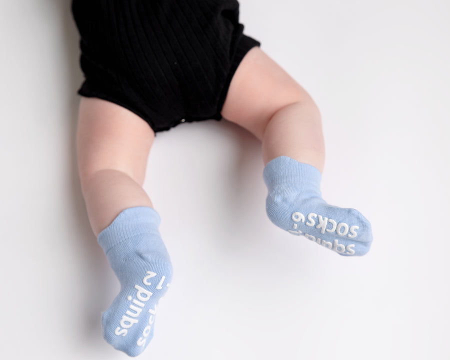 Chaney ankle socks: baby seated showing pale blue sock soles. Squid Socks, the brand seen on Shark Tank.