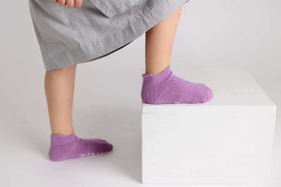 Ciara ankle socks: child stepping onto a block in lavender ankle socks. Squid Socks, the brand seen on Shark Tank.