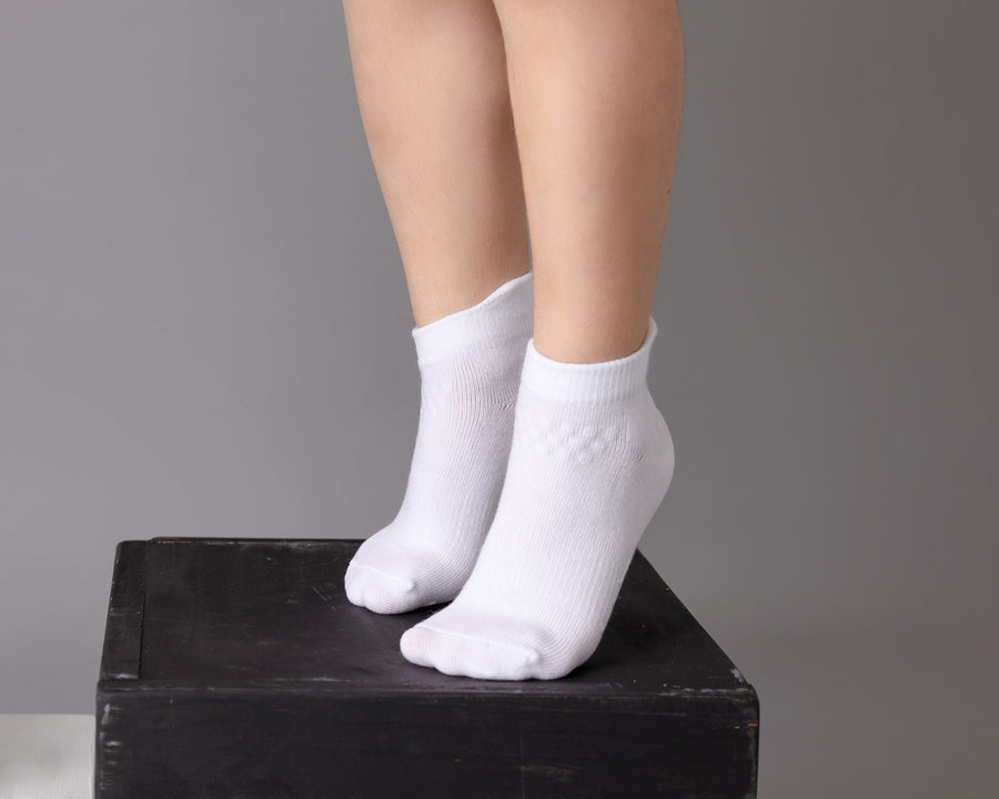 Cleary ankle socks: child standing on a block in white ankle socks. Squid Socks, the brand seen on Shark Tank.