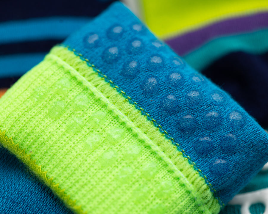 Clint kids socks: close-up of blue grip dots inside a neon green cuff. Squid Socks, the brand seen on Shark Tank.