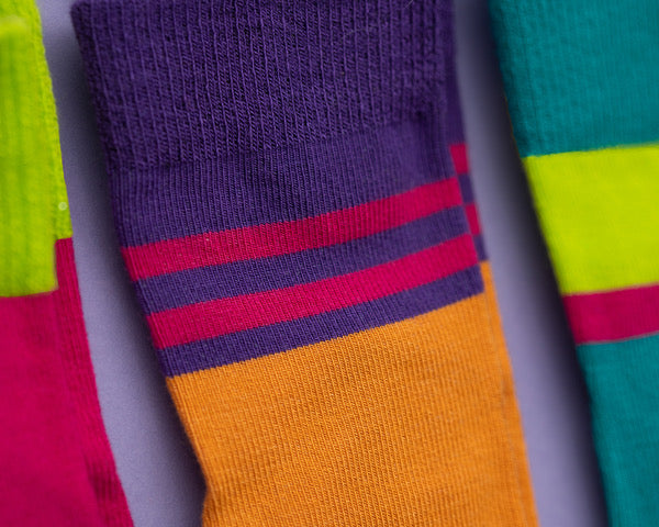 CeCe kids socks: close-up of orange socks with purple striped cuffs. Squid Socks, the brand seen on Shark Tank.