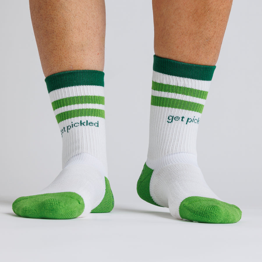 White Pickle Pack crew pickleball grip socks with green stripes and lime toe panels worn on both feet. By Squid Socks.
