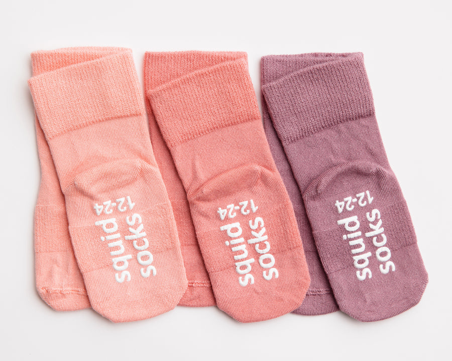 Cami kids socks: three pink and lavender socks with branded soles. Squid Socks, the brand seen on Shark Tank.
