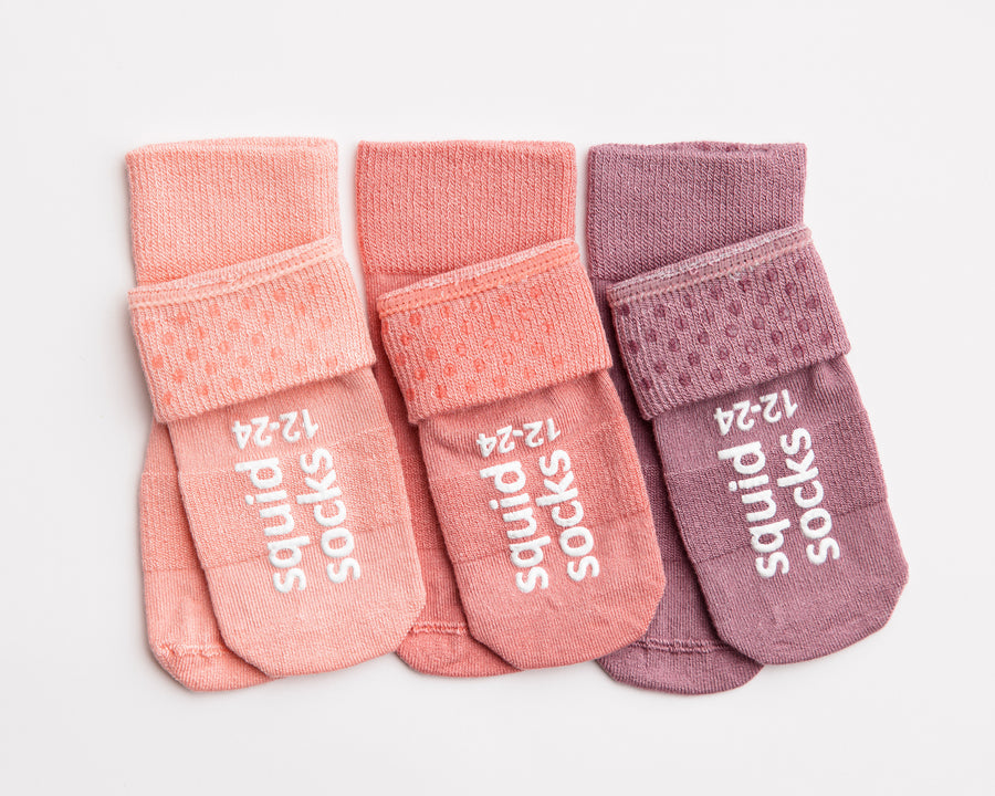 Cami kids socks: pink and lavender socks showing cuff and sole grips. Squid Socks, the brand seen on Shark Tank.