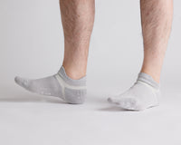 Thumbnail for Gray ankle grip socks worn with toes raised, showing side views. By Squid Socks.