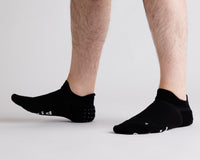 Thumbnail for Black ankle grip socks worn with toes raised, showing side views. By Squid Socks.