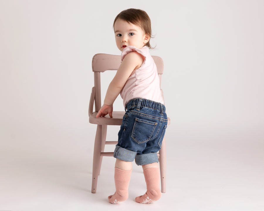 Courtney cotton crew socks: child standing by a chair in pale pink crew socks. Squid Socks, the brand seen on Shark Tank.