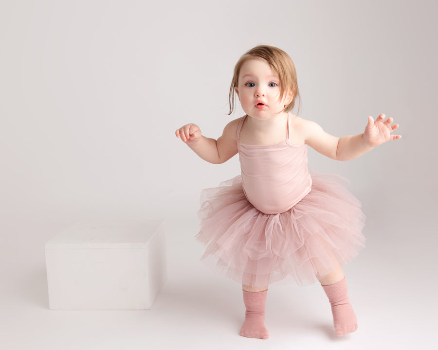 Claire kids socks: child standing in dusty rose socks and a tutu. Squid Socks, the brand seen on Shark Tank.