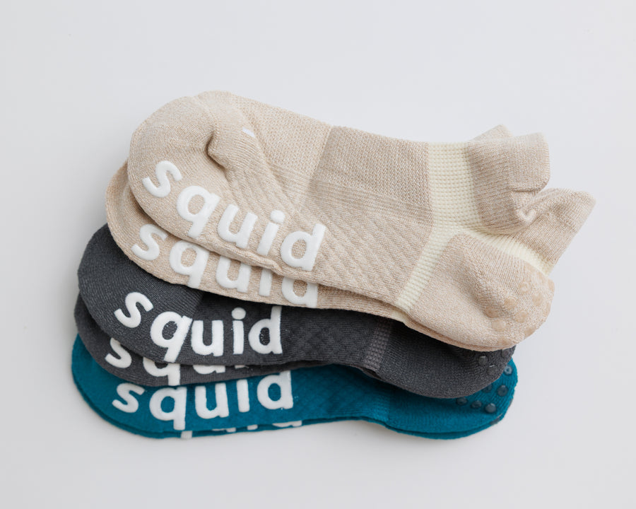 Driftline ankle grip socks in beige, charcoal gray, and teal, stacked to show all three colors. By Squid Socks.