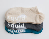 Driftline no-show grip socks in beige, charcoal gray, and teal, stacked to show all three colors. By Squid Socks.