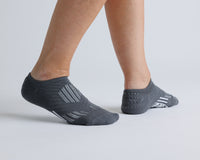Thumbnail for Charcoal gray no-show grip socks worn with heels raised, showing side views. By Squid Socks.