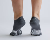 Thumbnail for Charcoal gray no-show grip socks viewed from behind, showing heel and bottom grips. By Squid Socks.