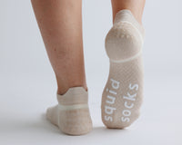 Thumbnail for Beige ankle grip socks with one sole raised to show white bottom grips. By Squid Socks.