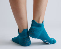 Thumbnail for Teal ankle grip socks viewed from behind, showing heel tabs and grip dots. By Squid Socks.