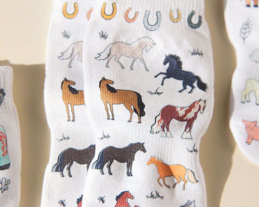 Cowboy kids socks: close-up of horses and horseshoe illustrations. Squid Socks, the brand seen on Shark Tank.