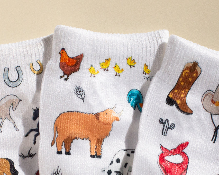 Cowboy kids socks: close-up of farm animal and cowboy boot prints. Squid Socks, the brand seen on Shark Tank.