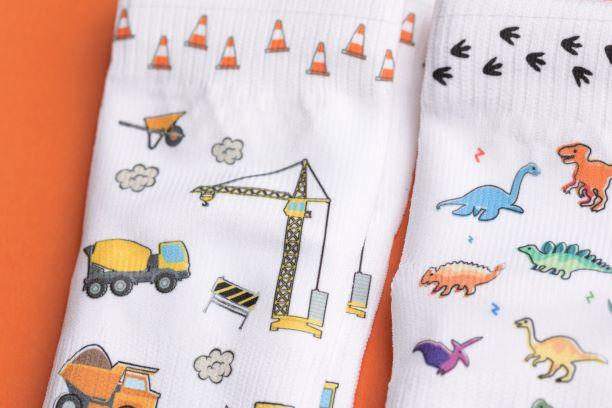 Cohen kids socks: close-up of construction equipment and dinosaur prints. Squid Socks, the brand seen on Shark Tank.