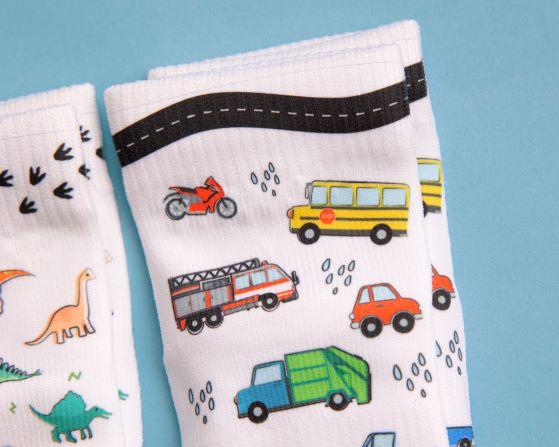 Cohen kids socks: vehicle-print cuff beside a dinosaur sock. Squid Socks, the brand seen on Shark Tank.