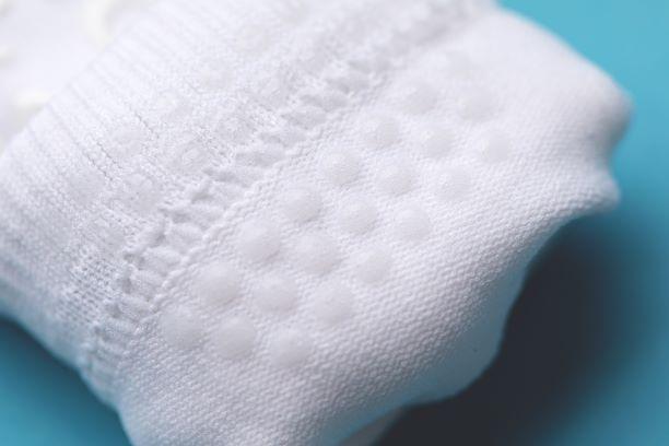 Camping kids socks: close-up of silicone grip dots inside a white cuff. Squid Socks, the brand seen on Shark Tank.