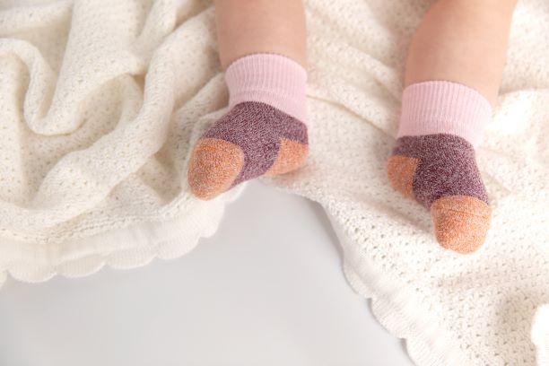Chelsea cotton crew socks: baby wearing pink-cuff crew socks on a blanket. Squid Socks, the brand seen on Shark Tank.