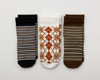 Chesney kids socks: black stripes, white argyle and brown stripes laid flat. Squid Socks, the brand seen on Shark Tank.