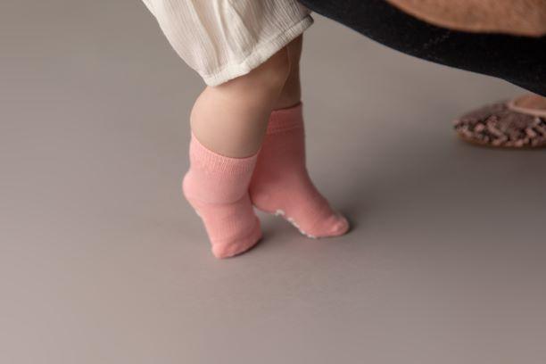 Cami kids socks: child standing on tiptoe in pink socks. Squid Socks, the brand seen on Shark Tank.