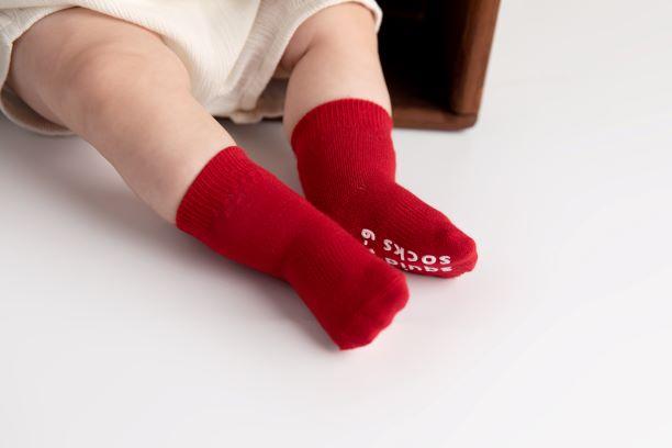 Channing kids socks: baby wearing red socks. Squid Socks, the brand seen on Shark Tank.