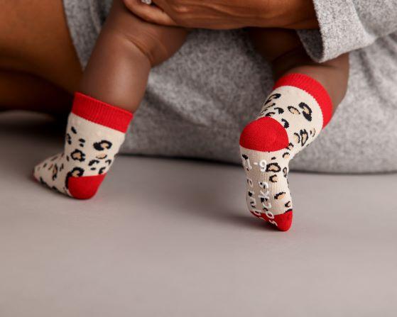 Chanel kids socks: baby wearing red-cuff leopard socks. Squid Socks, the brand seen on Shark Tank.