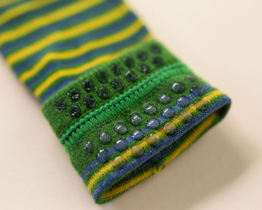 Colin kids socks: close-up of grip dots inside a green striped cuff. Squid Socks, the brand seen on Shark Tank.