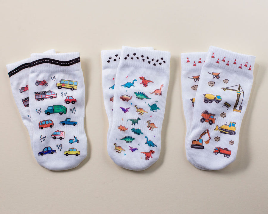 Cohen kids socks: three white socks with vehicle, dinosaur and construction prints. Squid Socks, the brand seen on Shark Tank.