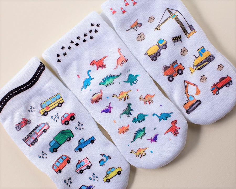 Cohen kids socks: vehicle, dinosaur and construction socks arranged together. Squid Socks, the brand seen on Shark Tank.