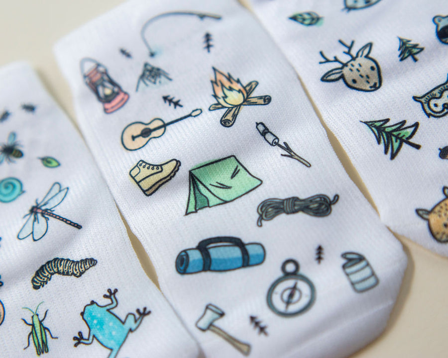 Camping kids socks: close-up of camping gear and bug-print socks. Squid Socks, the brand seen on Shark Tank.
