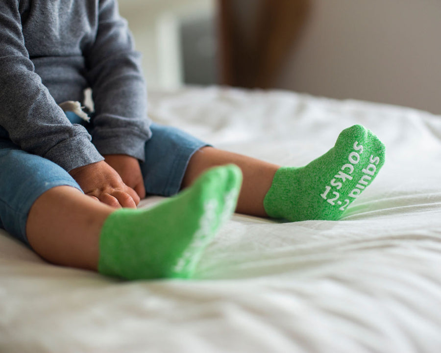 Chevy ankle socks: child seated wearing green ankle socks. Squid Socks, the brand seen on Shark Tank.