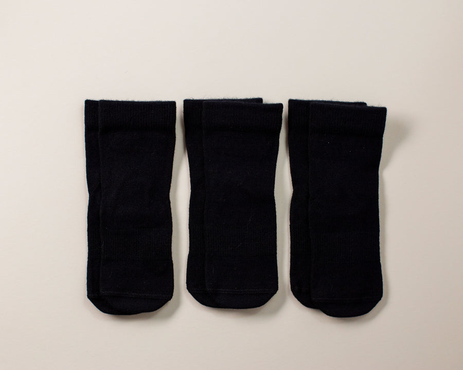 Coal kids socks: three solid black socks laid flat. Squid Socks, the brand seen on Shark Tank.