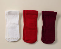 Channing kids socks: three red, cream and wine-colored socks laid flat. Squid Socks, the brand seen on Shark Tank.