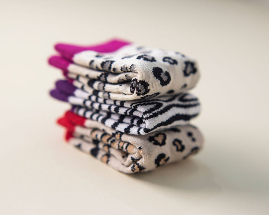 Chanel kids socks: stack of leopard and zebra-print socks. Squid Socks, the brand seen on Shark Tank.