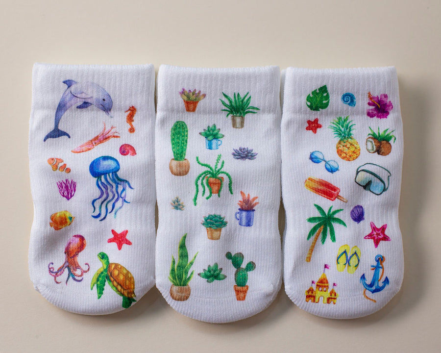 Caribbean kids socks: three white socks with ocean, cactus and tropical prints. Squid Socks, the brand seen on Shark Tank.